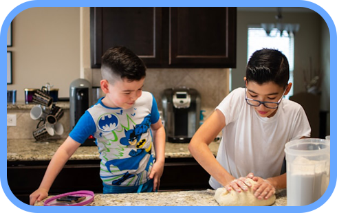 こども二人が料理をしている。